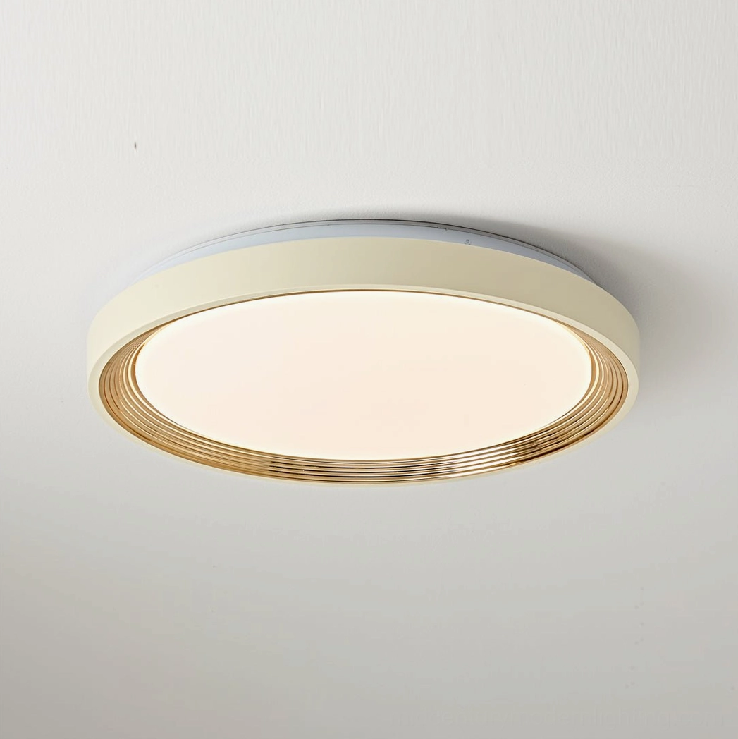 Cerova round flush mount with smooth cream frame and gold metallic trim, close-up front view