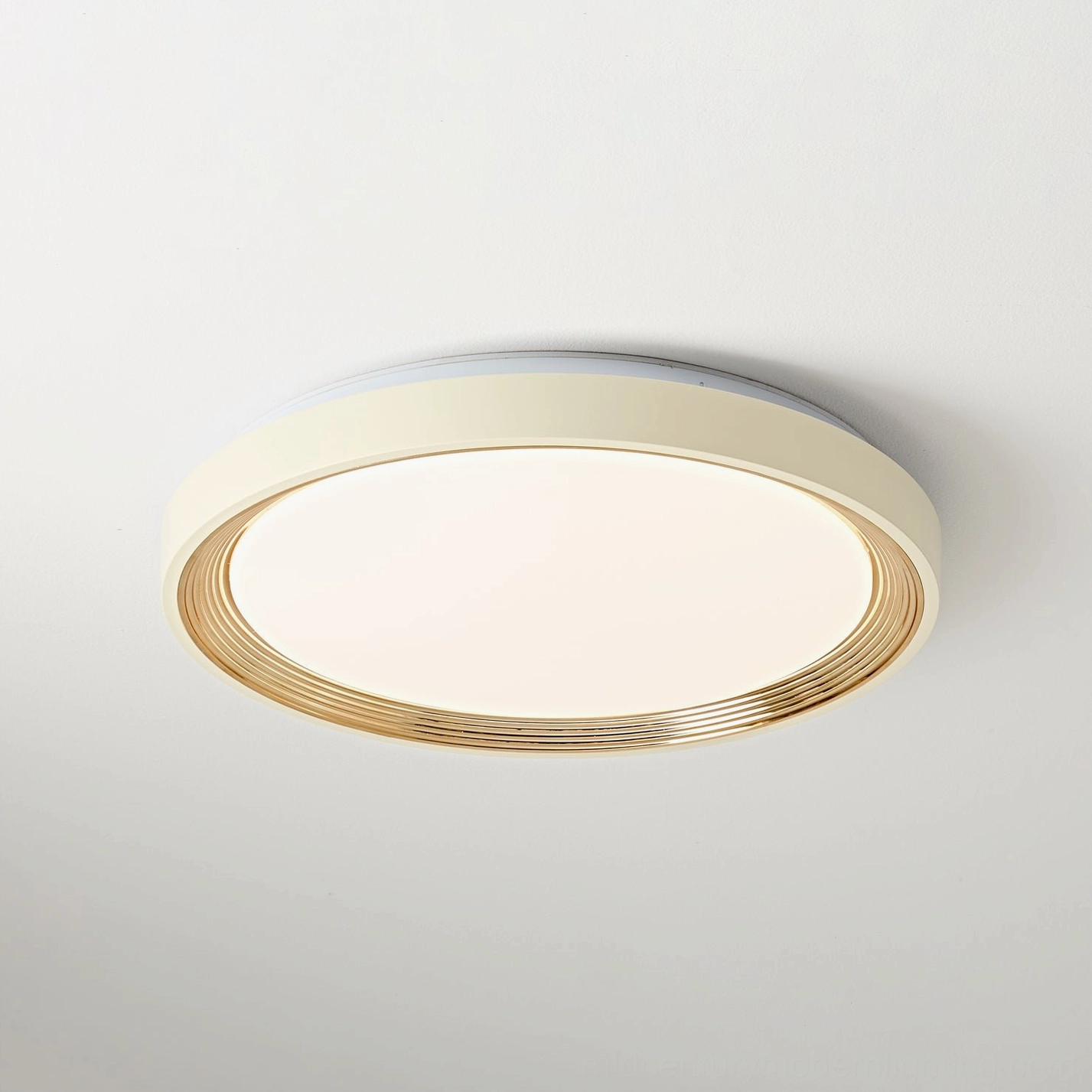 Cerova ceiling fixture featuring cream frame with gold ribbed metallic trim, studio overhead view