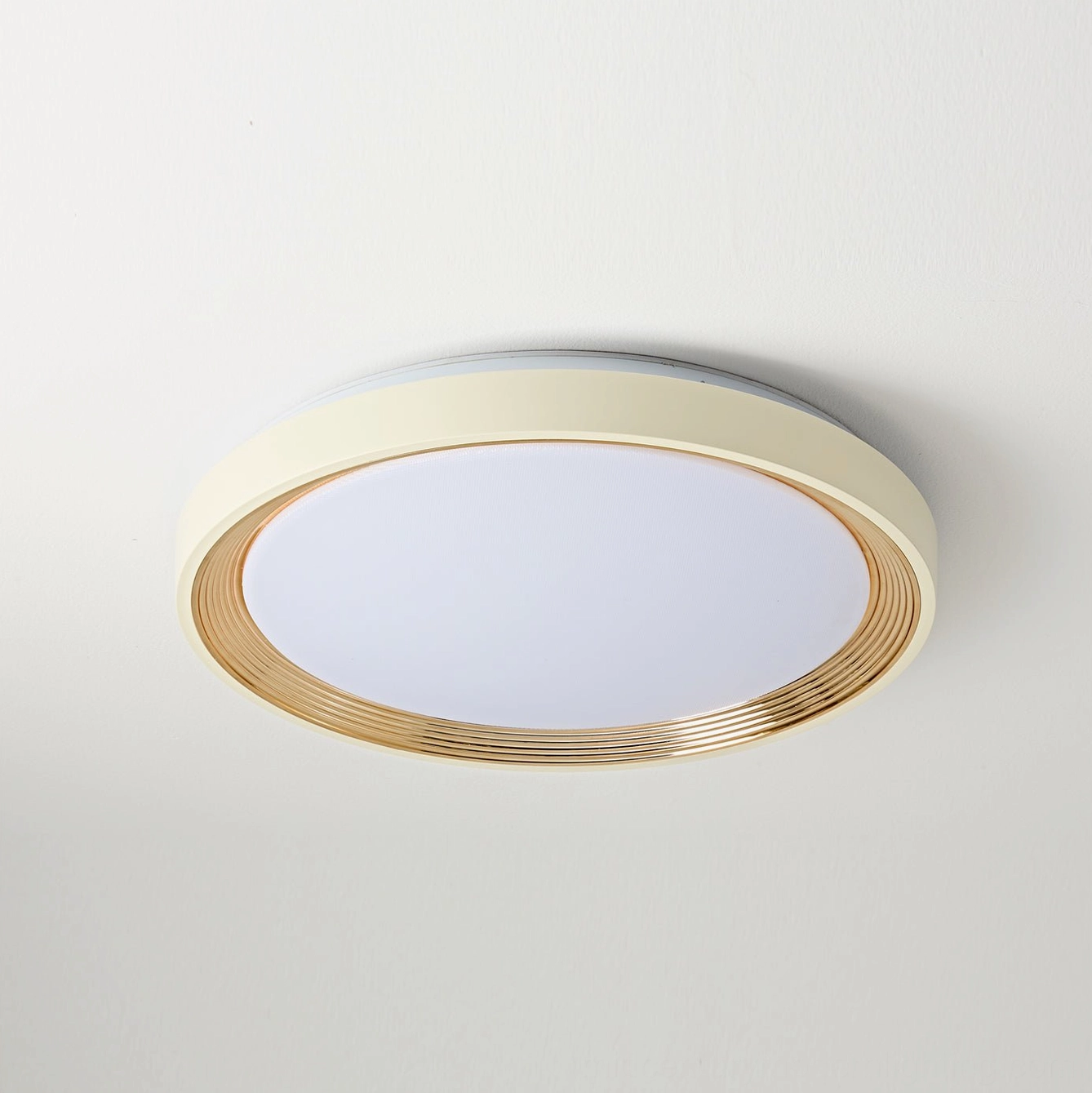 Cerova LED ceiling light with cream finish and gold trim showing frosted white diffuser panel