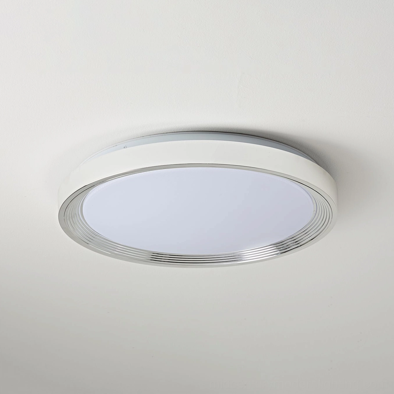 Cerova round ceiling light creating warm ambient lighting in dining room table setting