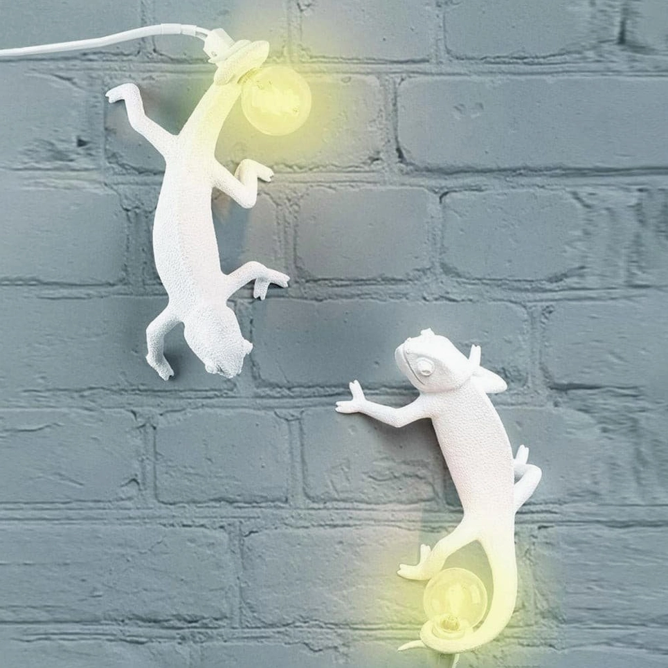 Three chameleon wall sconces on cartoon tropical leaf background, playful modern lighting display
