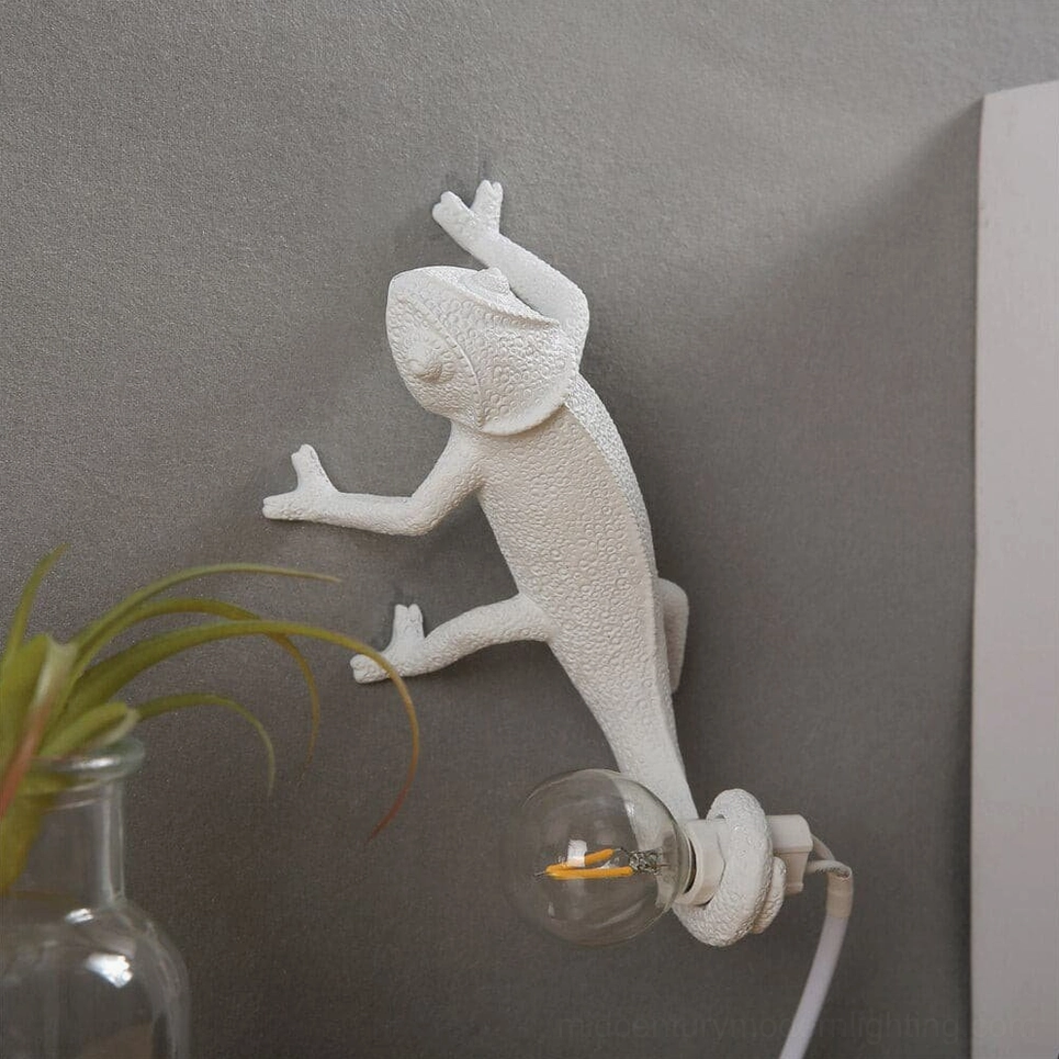 Chameleon wall sconce in home interior corner with green potted plant and glass vase, bohemian styling