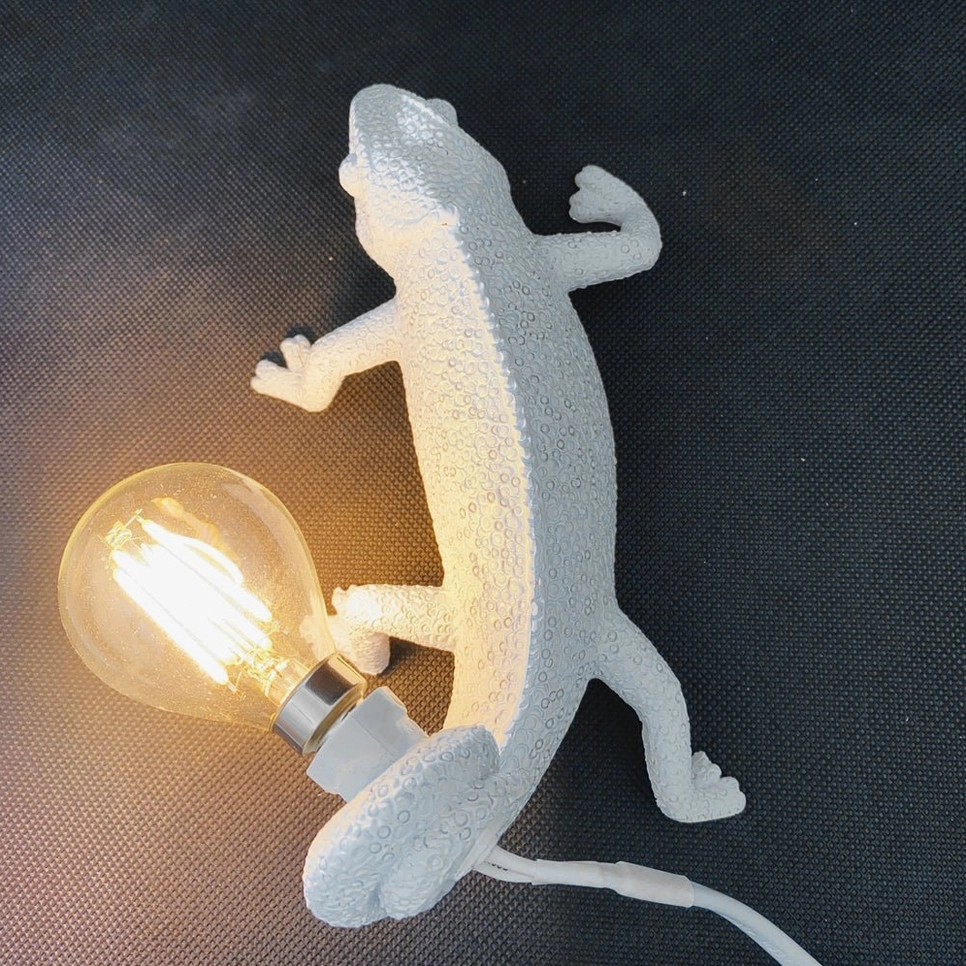Chameleon wall light with textured matte resin finish, overhead angled view showcasing sculptural details
