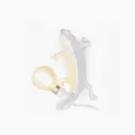Chameleon wall sconce with vintage Edison filament bulb on white background, matte white resin sculptural lighting fixture
