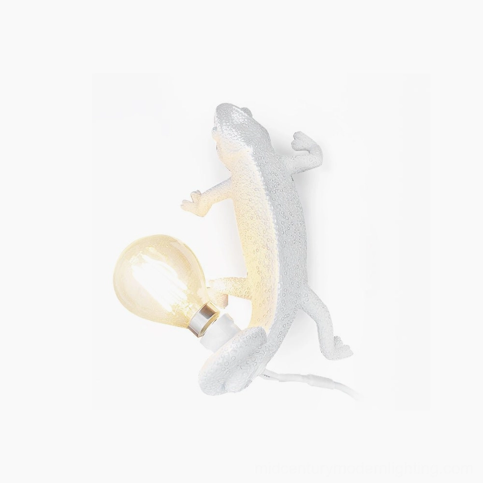 Chameleon wall sconce with vintage Edison filament bulb on white background, matte white resin sculptural lighting fixture