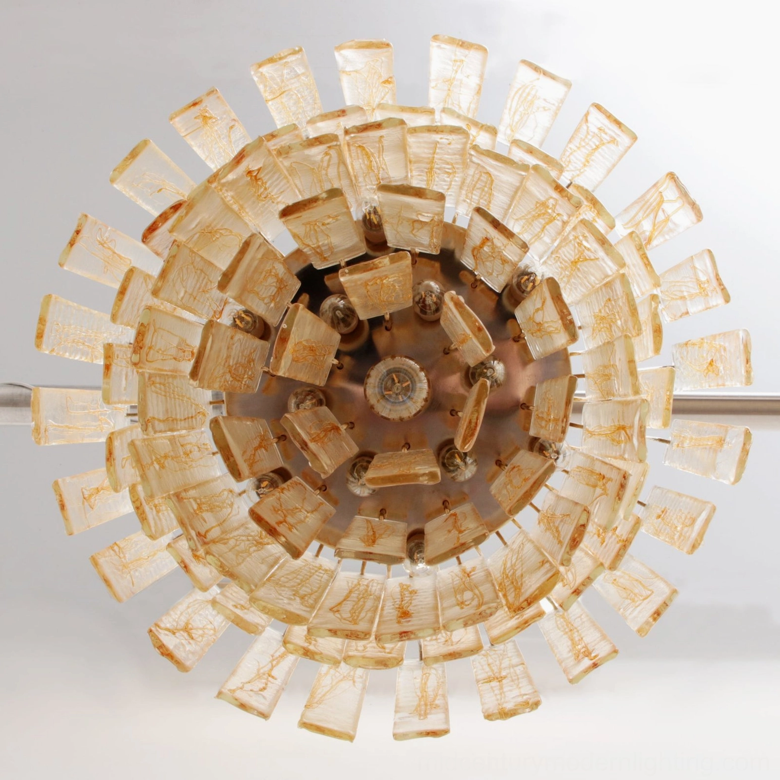 Underside mounting detail revealing radial metal hardware, securing clips, and ceiling installation assembly