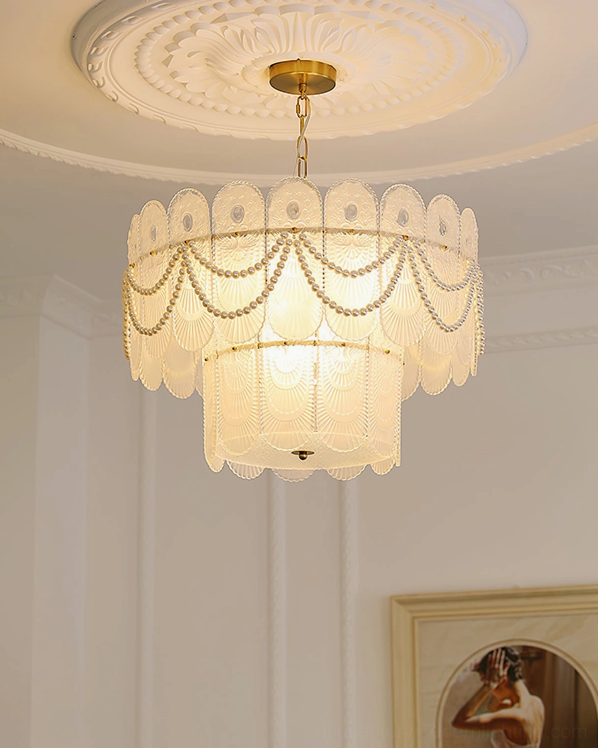 Ceiling-mounted scalloped glass chandelier in formal French-style interior with crown molding and decorative ceiling medallion, upward angle showing warm ambient glow