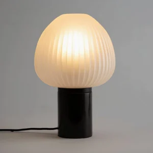 Chanya lamp illuminated showing warm yellow light transmission through frosted glass shade, modern minimalist lighting