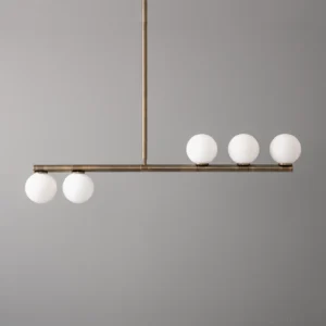 Mid-century modern linear pendant chandelier featuring five matte white glass spheres suspended on bronze metal rod, frontal view