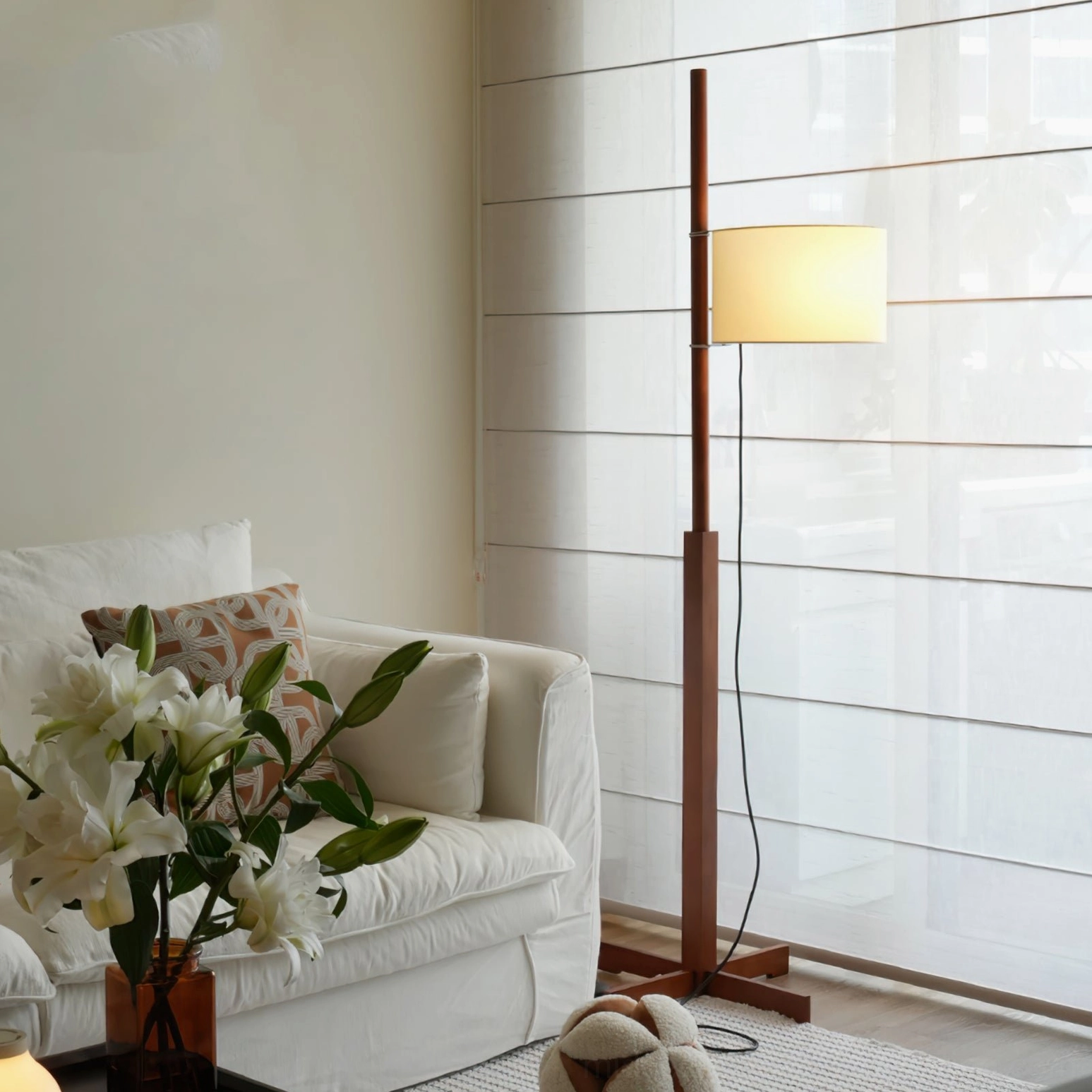 Cherry wood finish floor lamp with fabric shade in Scandinavian minimalist setting