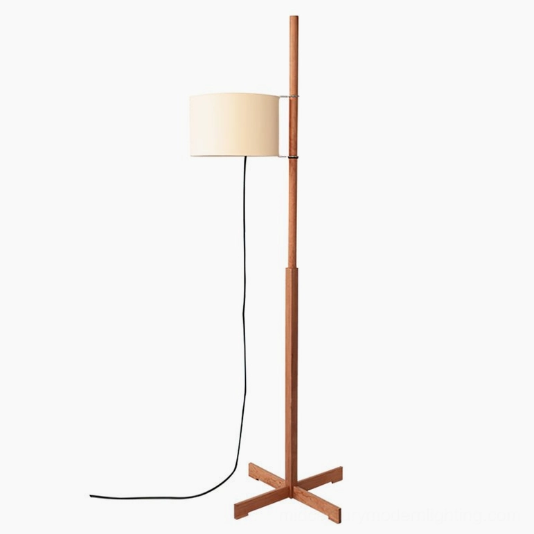 Cherry wood wooden floor lamp with warm fabric shade in contemporary home