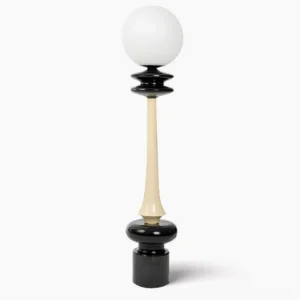 Chess floor lamp frontal view showing black and cream dual-tone sculptural design with frosted glass sphere