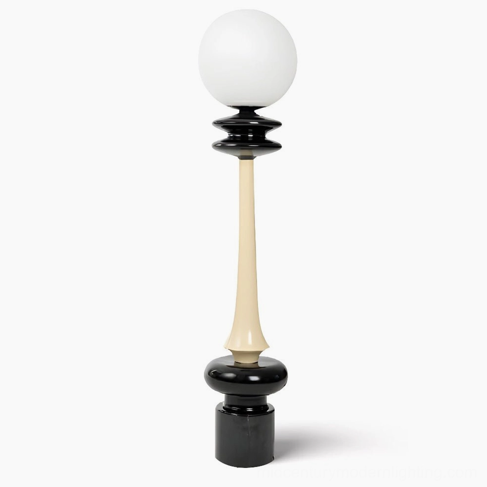 Chess floor lamp frontal view showing black and cream dual-tone sculptural design with frosted glass sphere