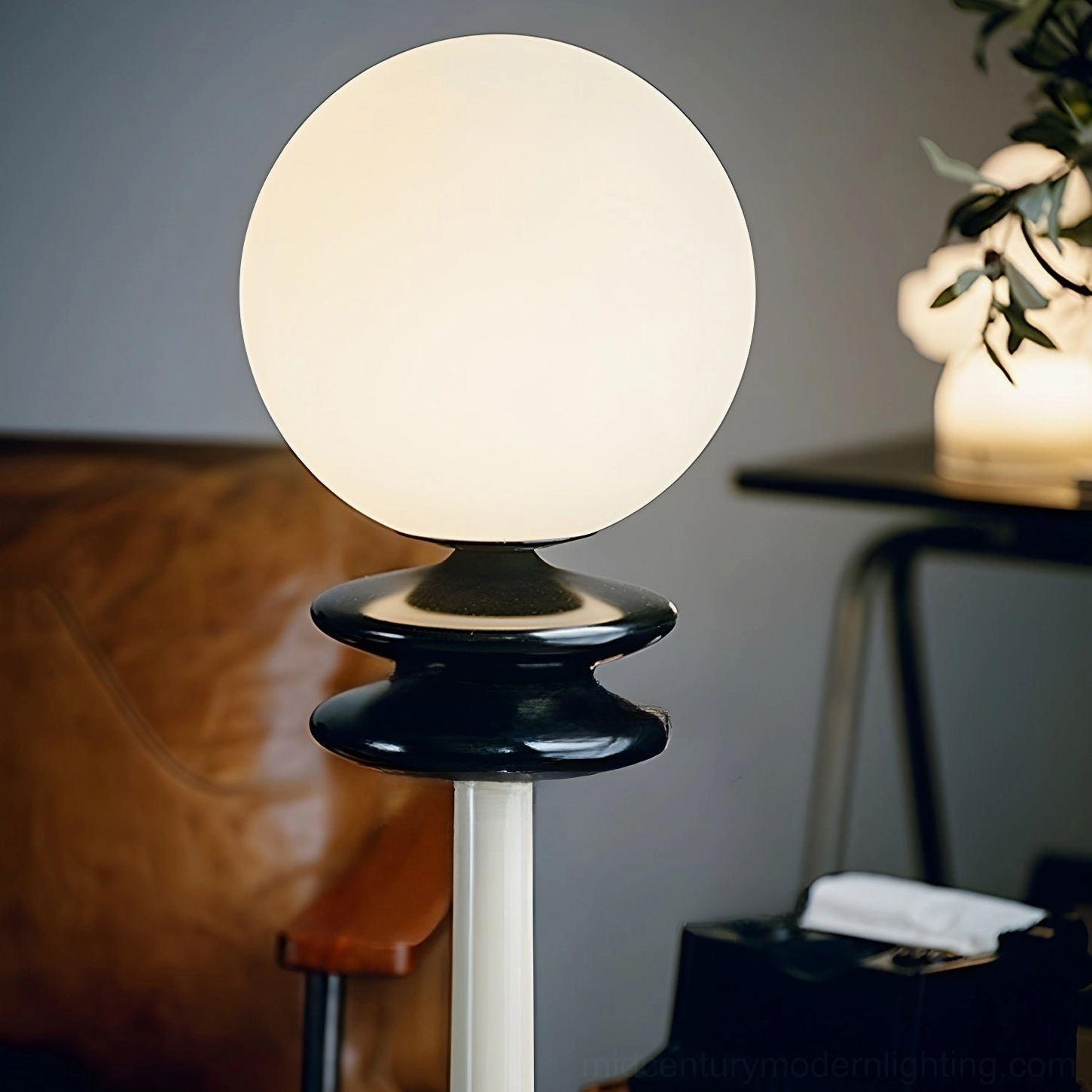 Illuminated chess floor lamp glowing warm light next to brown leather sofa