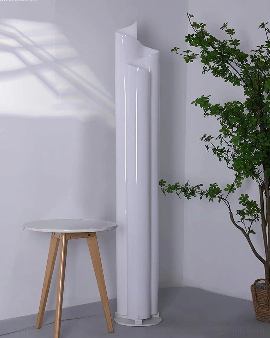 Unlit Chimera floor lamp beside side table and green foliage minimalist style