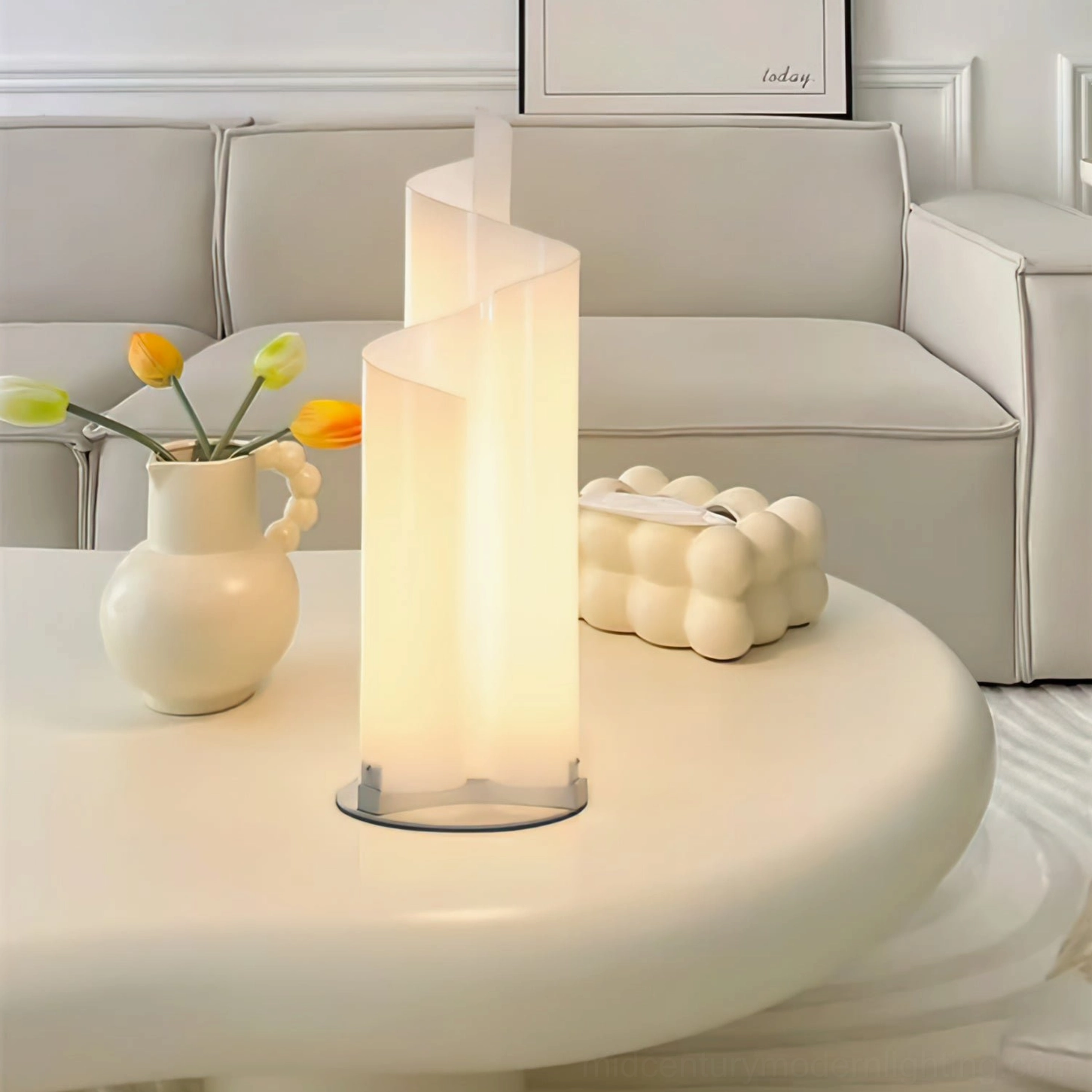 Chimera spiral table lamp glowing on modern coffee table with ceramic vase and decorative accents in neutral living room