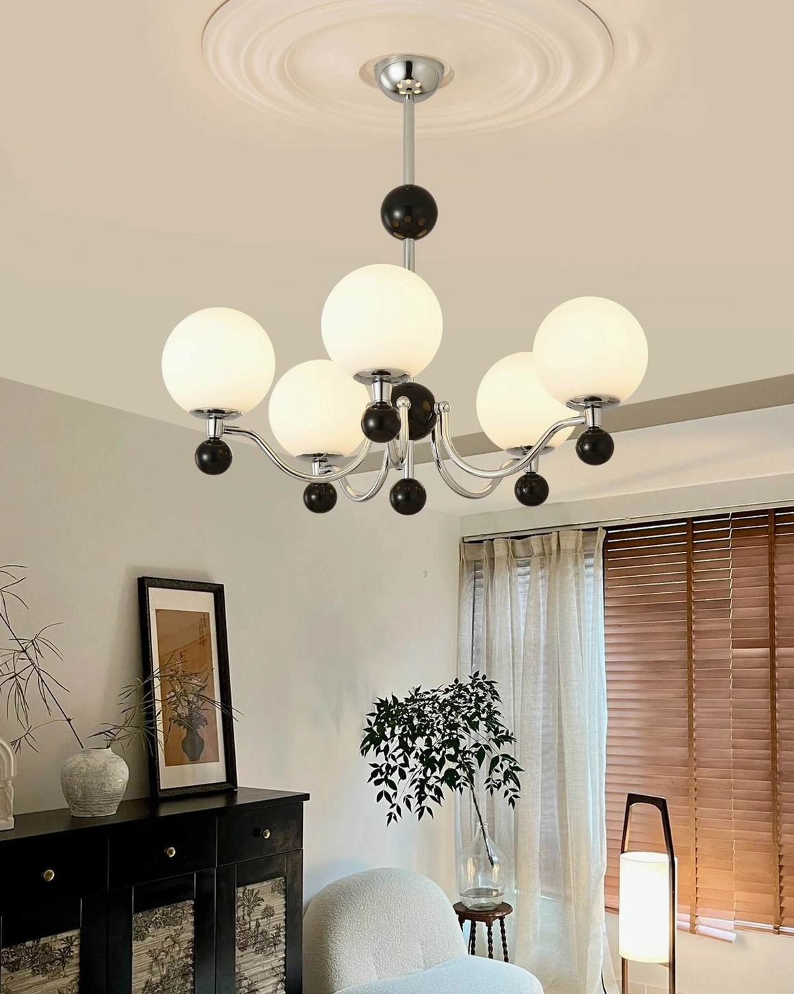 Modern spherical chrome chandelier detail shot showing frosted glass shades and polished hardware