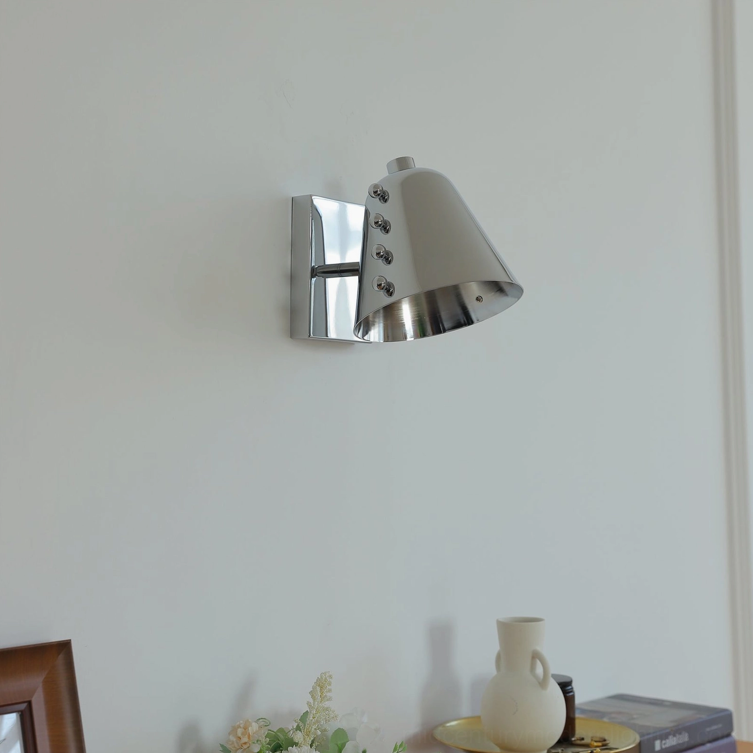 Chrome polished silver geometric wall lamp front view with studded shade on white background