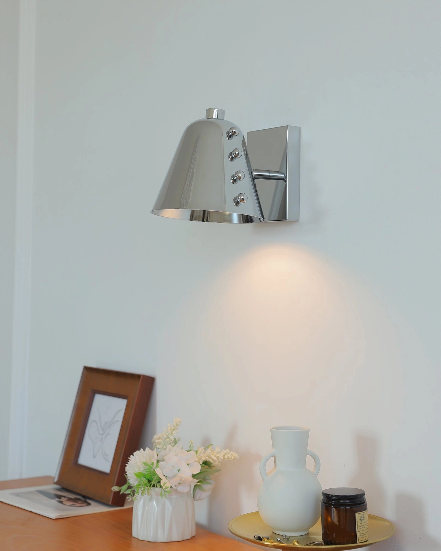 Chrome wall lamp in industrial chic setting with exposed brick and steel accents