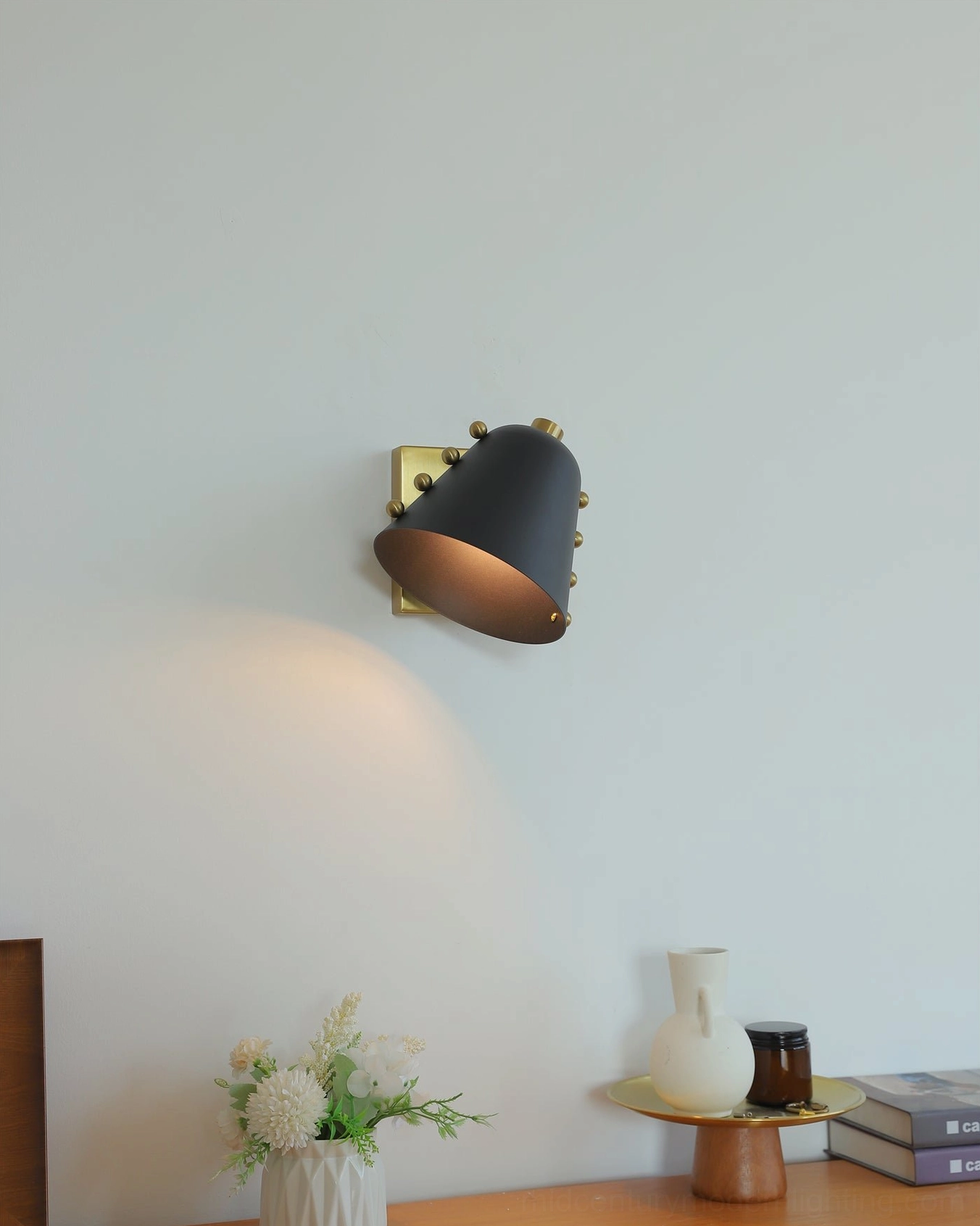 Chrome wall lamp mounted showing lighting throw pattern and shadow effect on wall