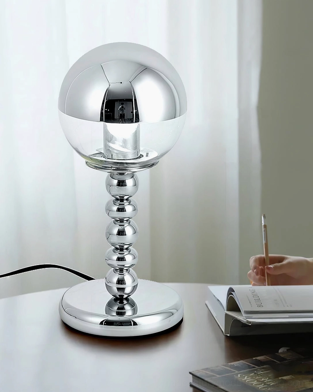 Stylized chrome Mirrorball lamp with half-sphere glass design and beaded metal base, minimalist accent
