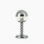 Chrome Mirrorball table lamp with half-mirrored half-clear glass sphere on beaded metal stem, studio front view