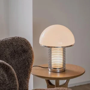 Mushroom style table lamp in living room setting on side table, three-quarter angle showing sculptural design