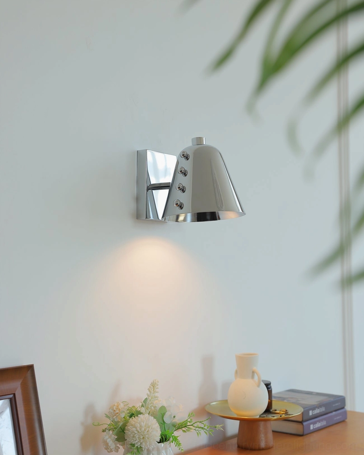 Chrome wall sconce eye-level side view tabletop display tilted shade soft warm lighting