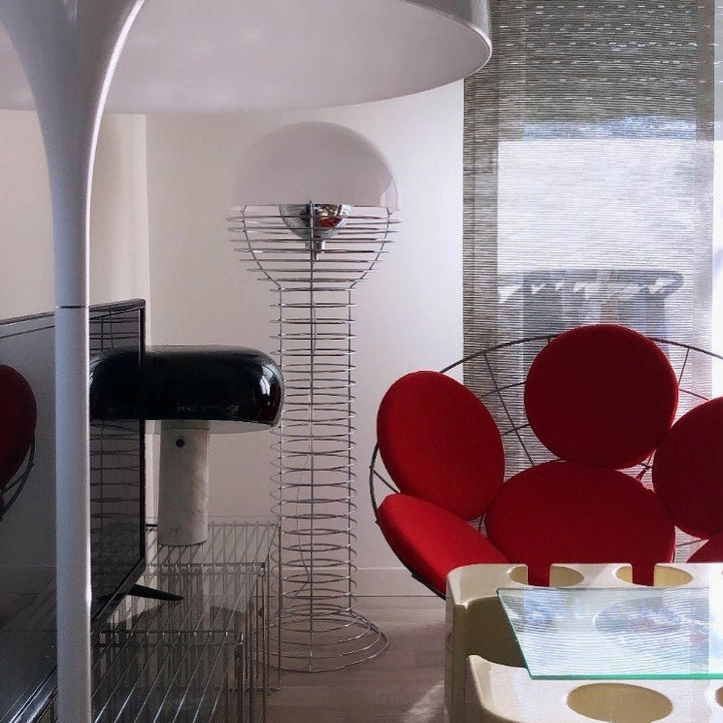 Chrome wire floor lamp with hemispherical shade shown in interior design context with modern furniture