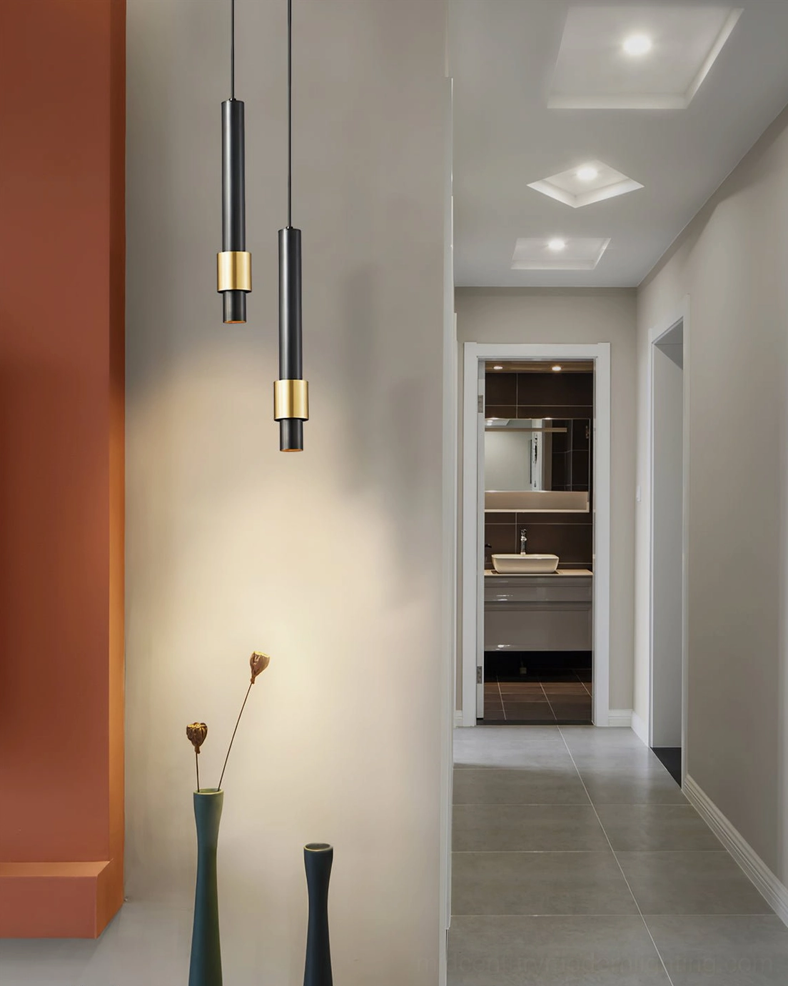 Dual black and gold Cicada pendant lamps in modern hallway, matching minimalist lighting fixtures