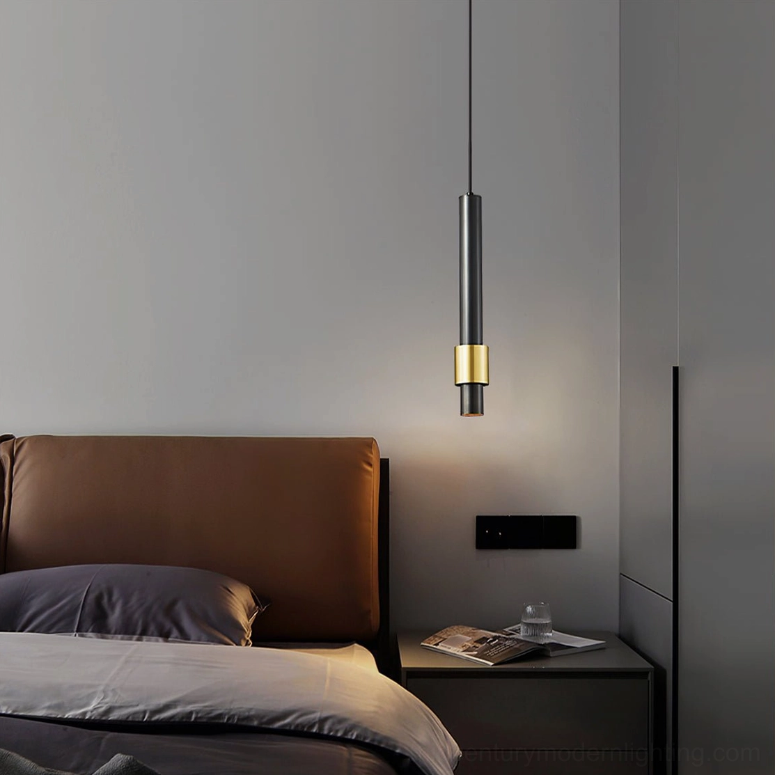 Contemporary bedroom accent lighting with Cicada pendant lamp, sleek cylindrical form beside brown leather headboard