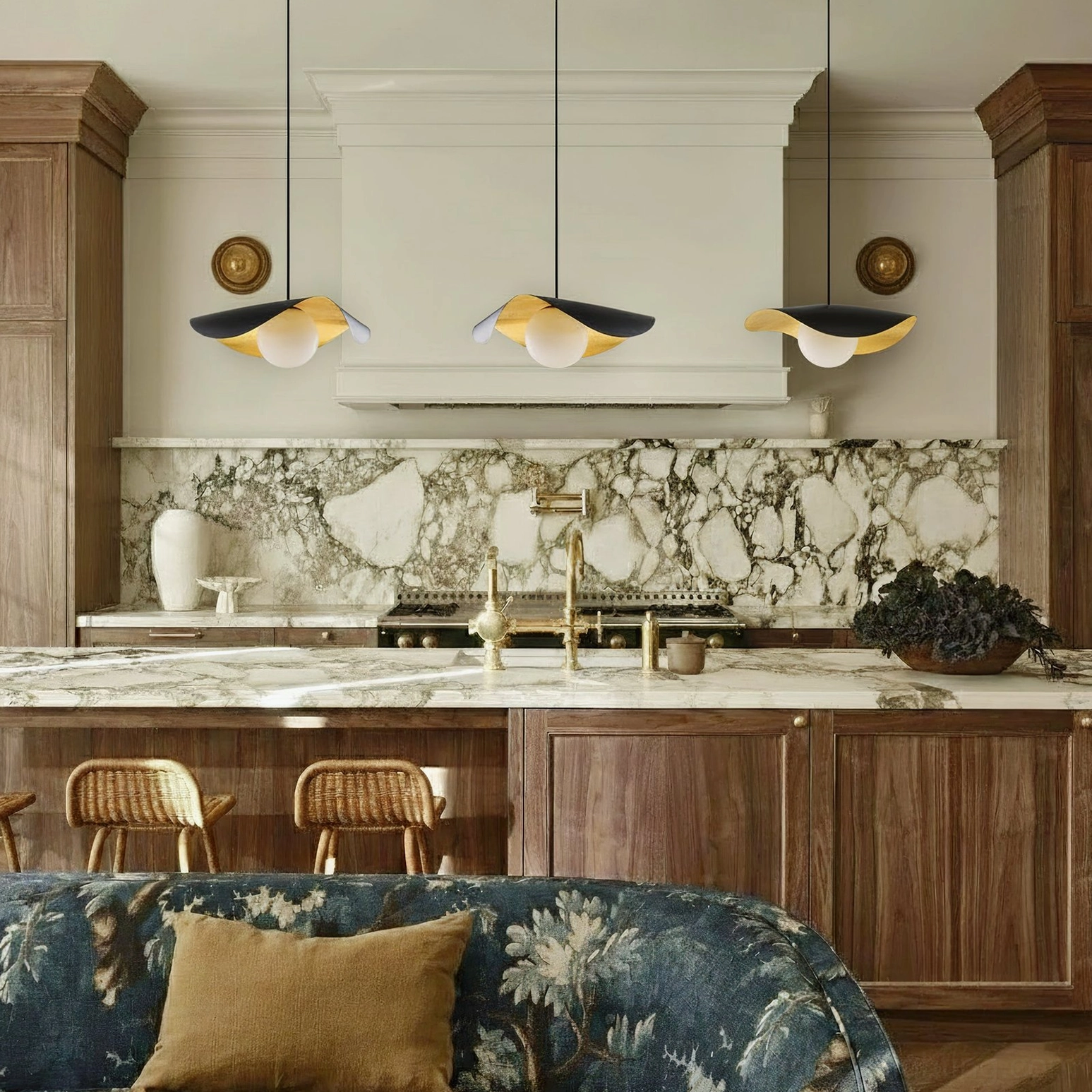 Triple Cilla pendant lamps installed above luxury kitchen with marble backsplash, uniform curved pendant design, cooking space lighting