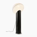 Ciot modern floor lamp with black glossy pole and white dome shade, front view in studio setting