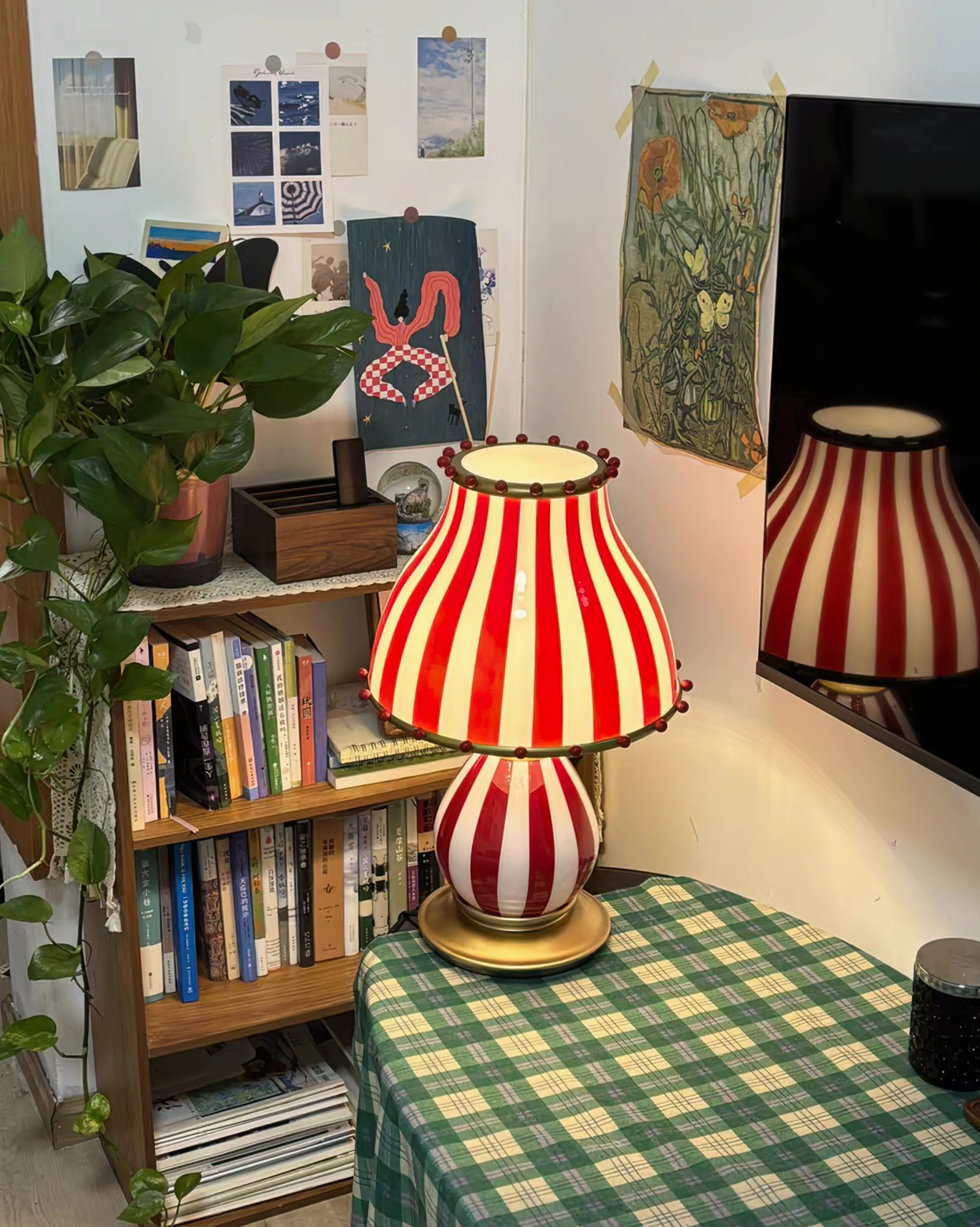 Striped circus vintage lamp in gallery wall display with vintage posters and art