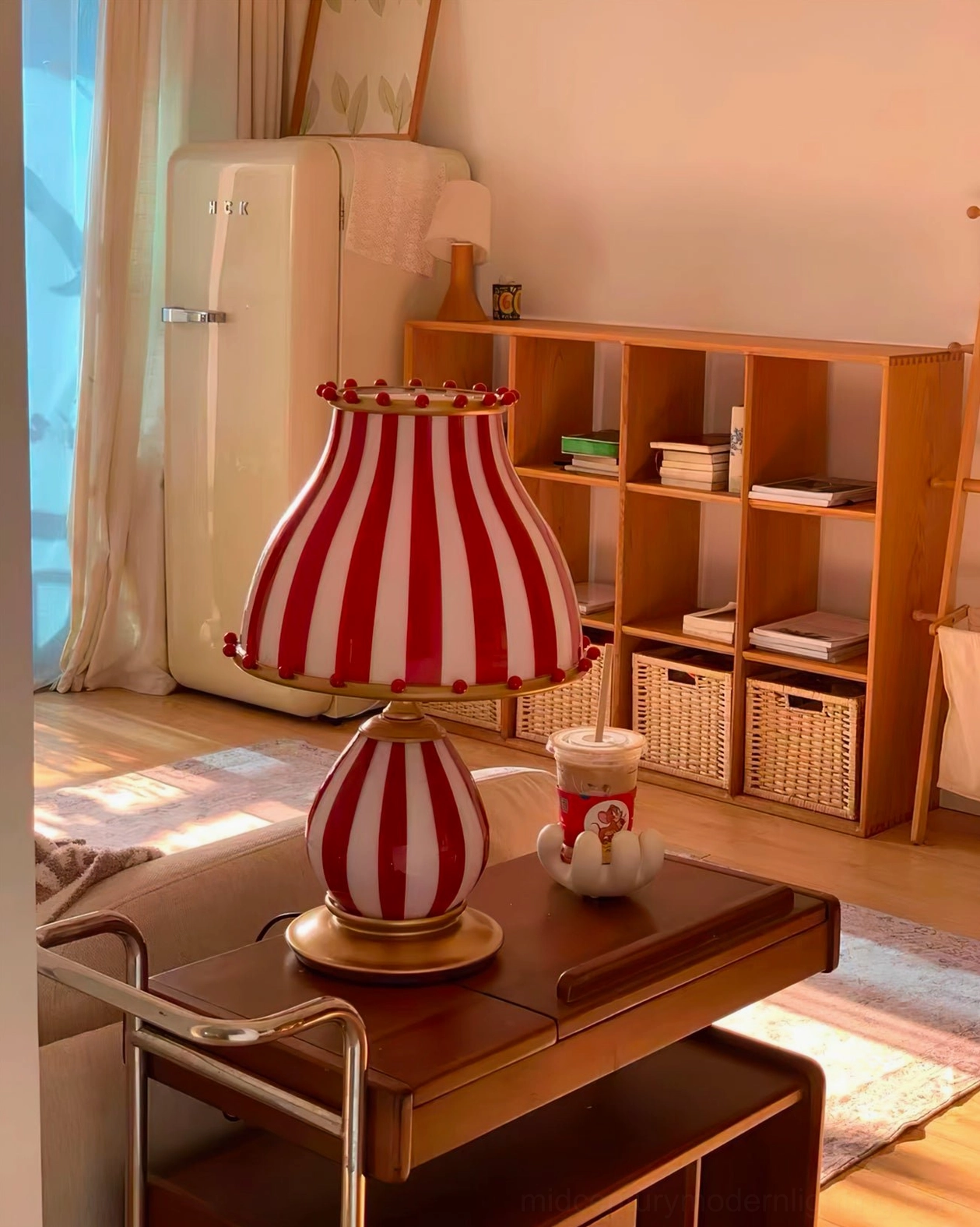 Carnival-themed red and white striped table lamp with gold accents studio view