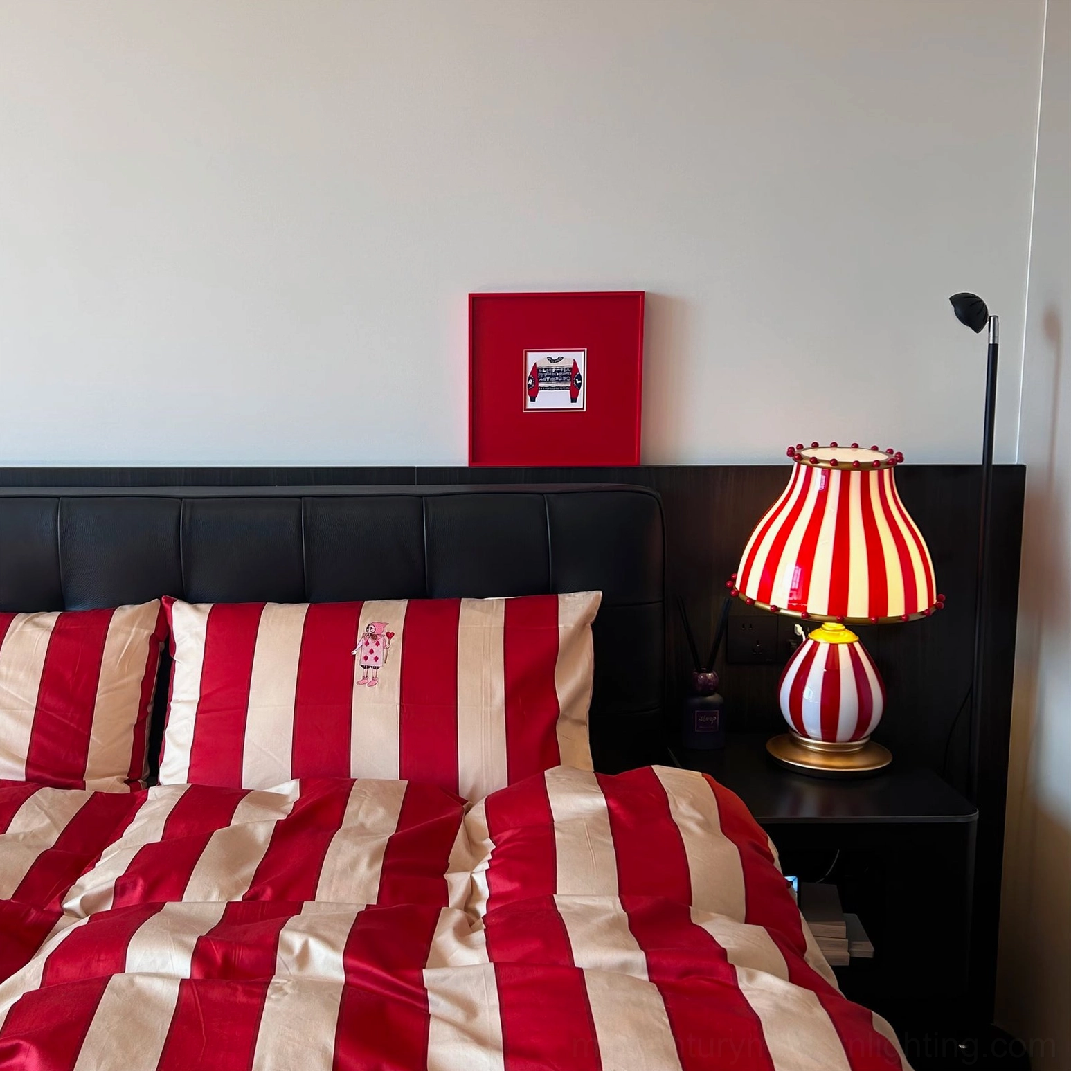 Striped vintage circus lamp paired with complementary mid-century modern furnishings