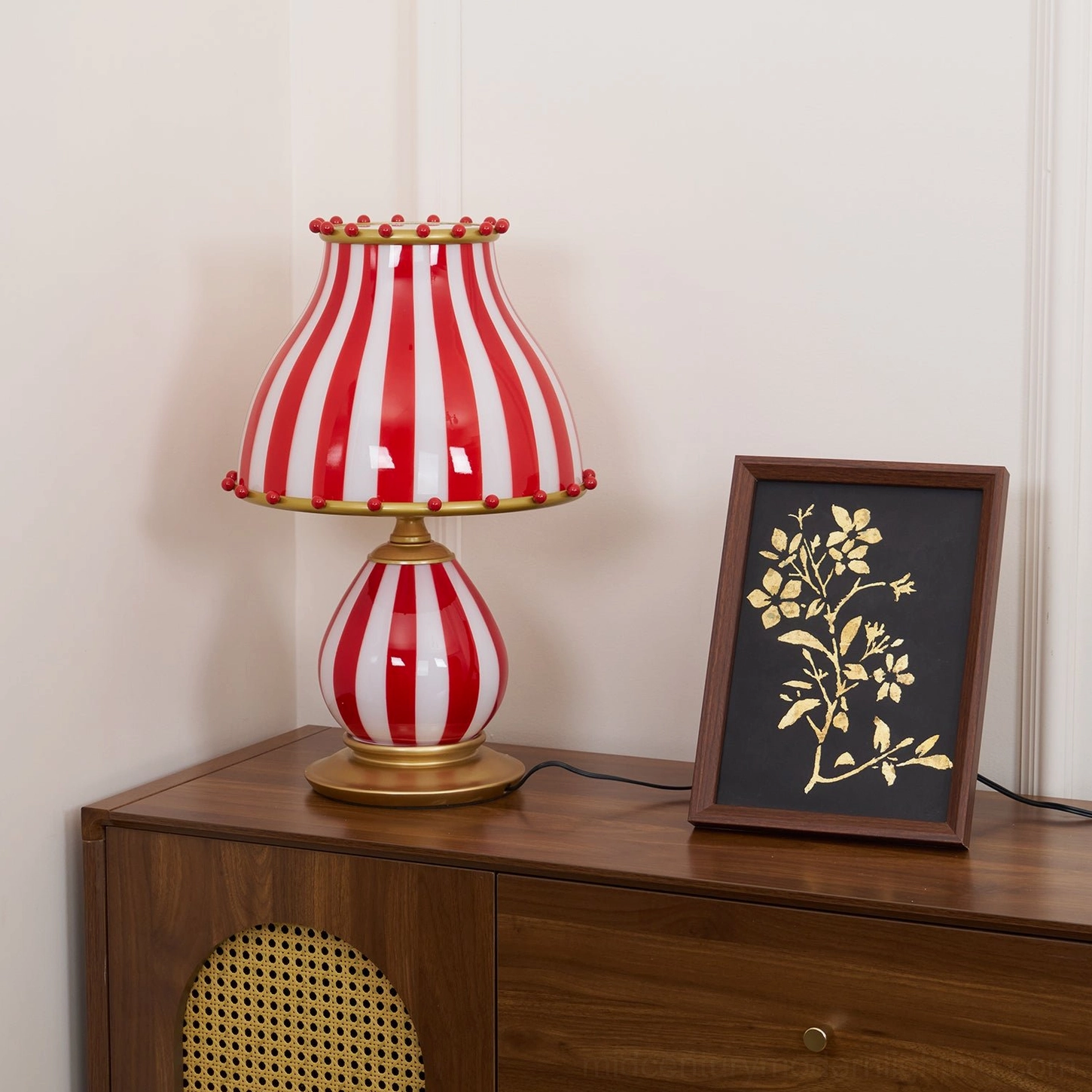 Carnival striped table lamp positioned as statement piece in eclectic room setting