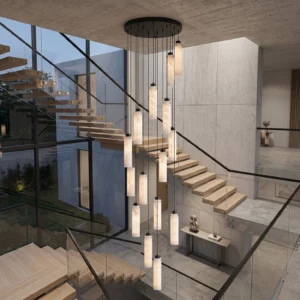 Cirio multi-pendant chandelier installed in modern double-height stairwell with warm alabaster glow