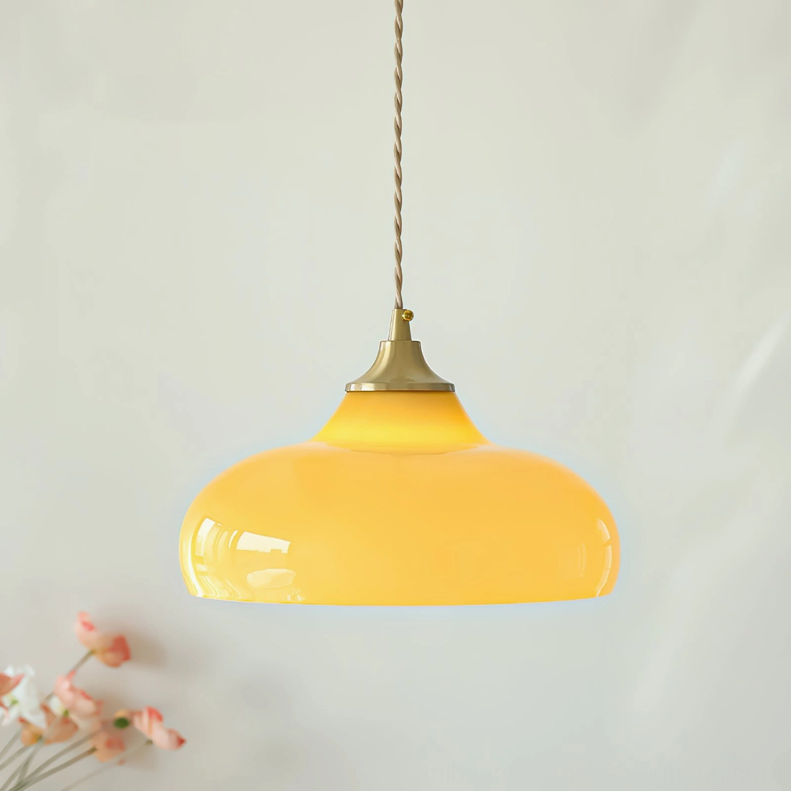 Close-up side view of glossy yellow glass dome pendant lamp showing smooth ceramic finish and brass details