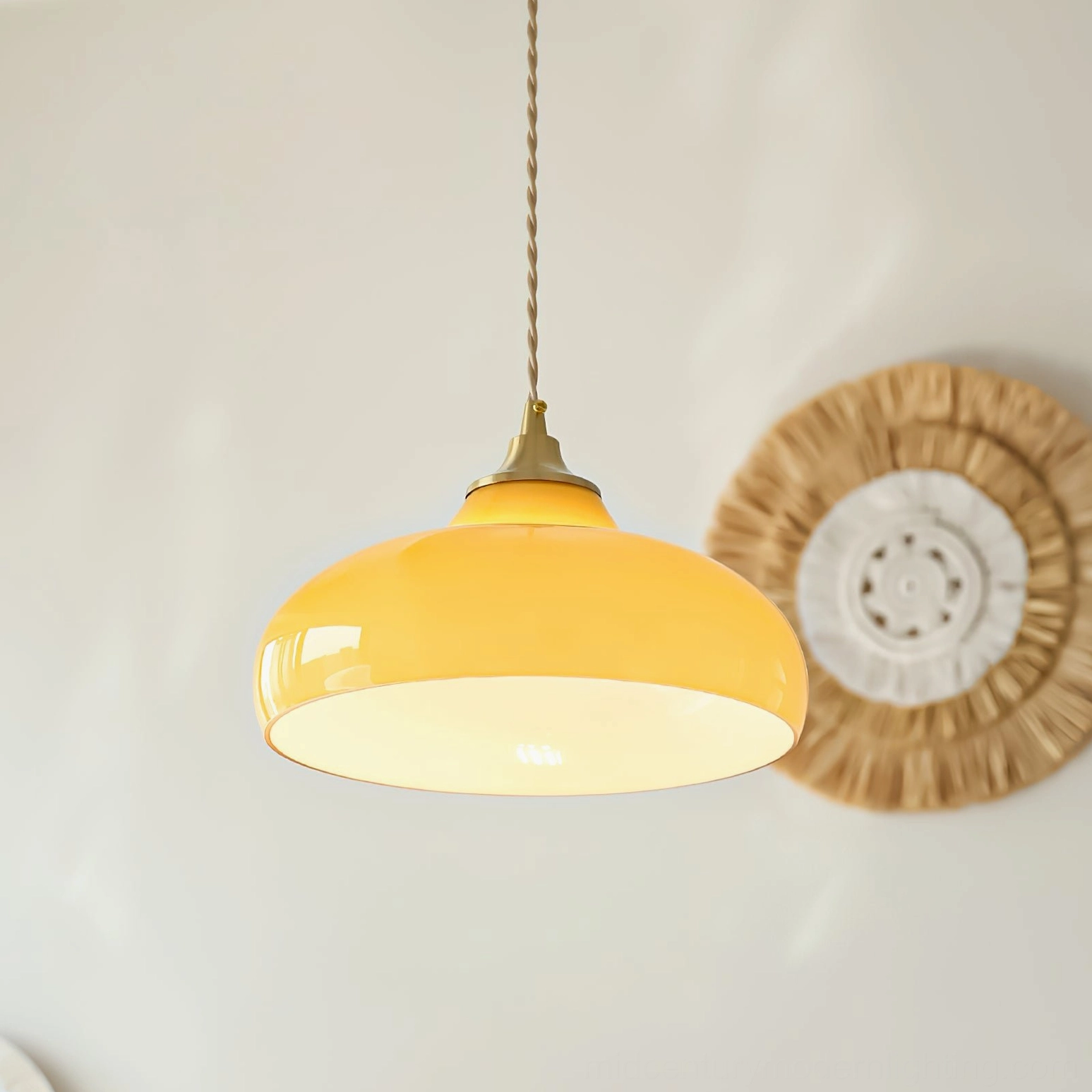Citrine dome pendant lamp with twisted cord displayed alongside woven wall textile in rustic nordic style