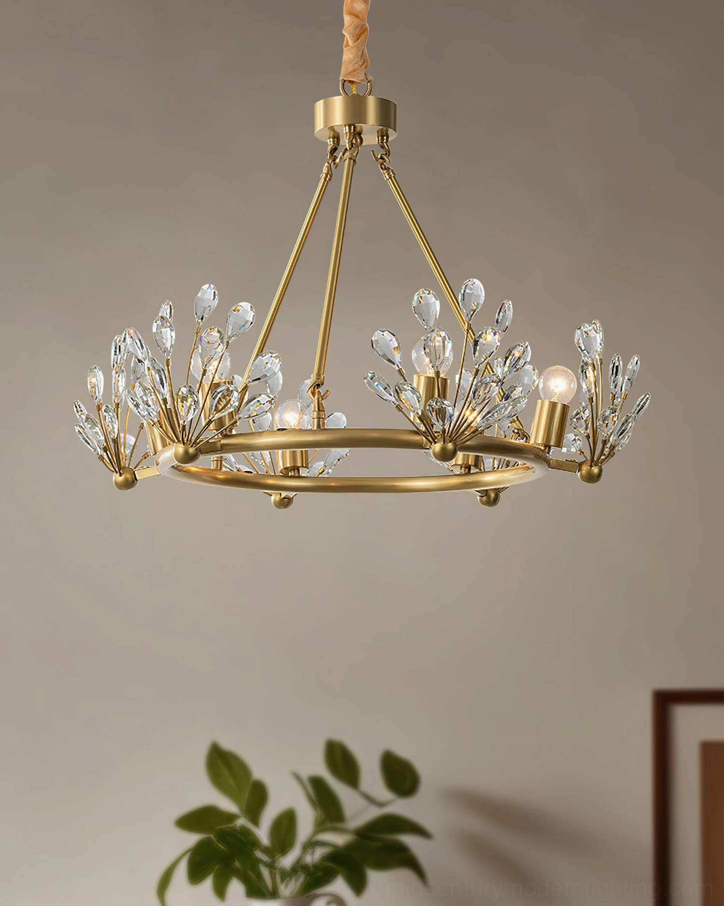 Compact Clara Crystal Chandelier three-quarter view with clustered crystal bud accents, displayed in elegant indoor setting with green plant decor