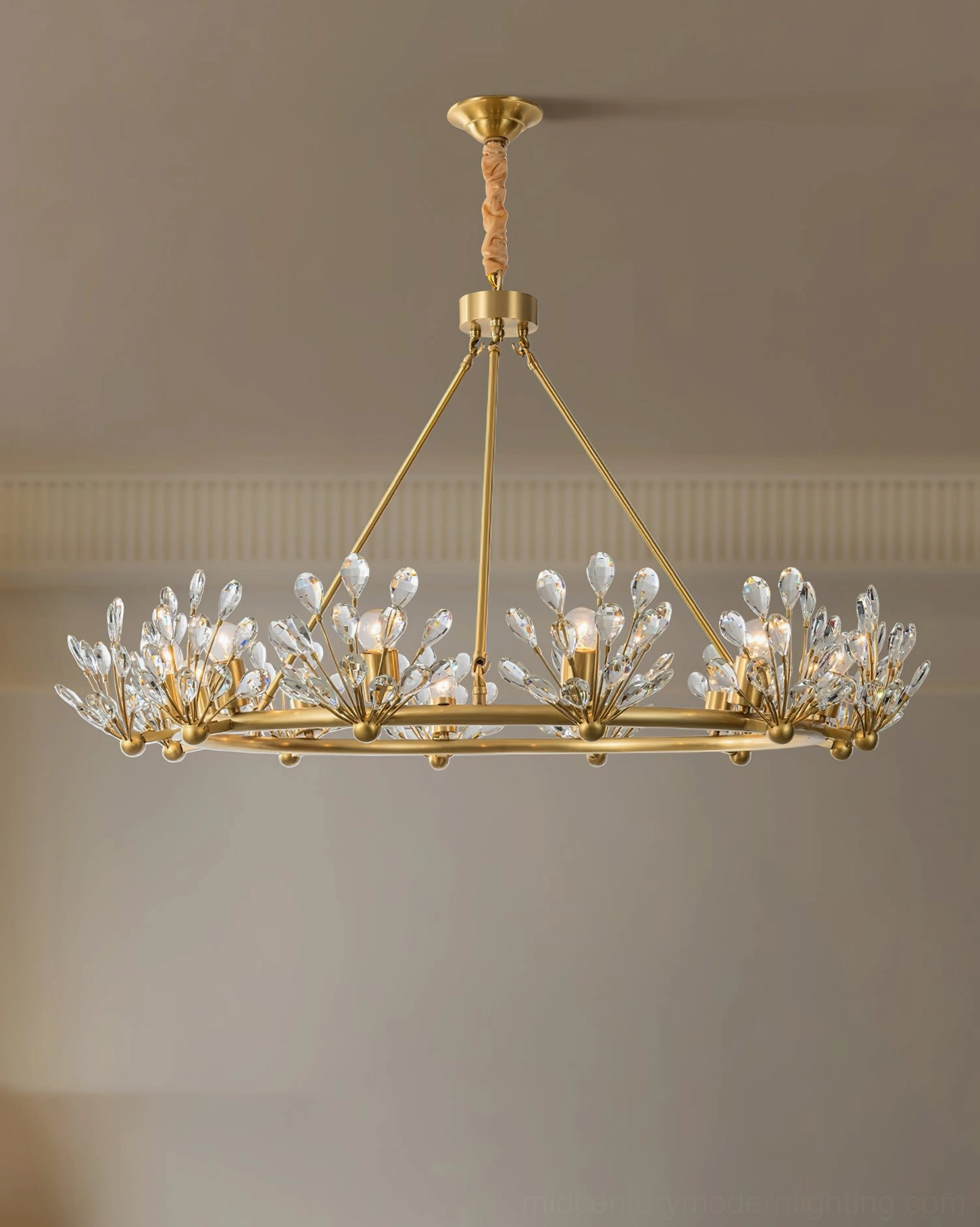Large circular Clara Crystal Chandelier with multiple crystal light sets arranged around wide brass ring, ceiling installation example in modern interior