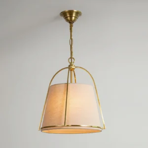 Clarke pendant lamp three-quarter angle showing polished brass frame and woven fabric lampshade detail