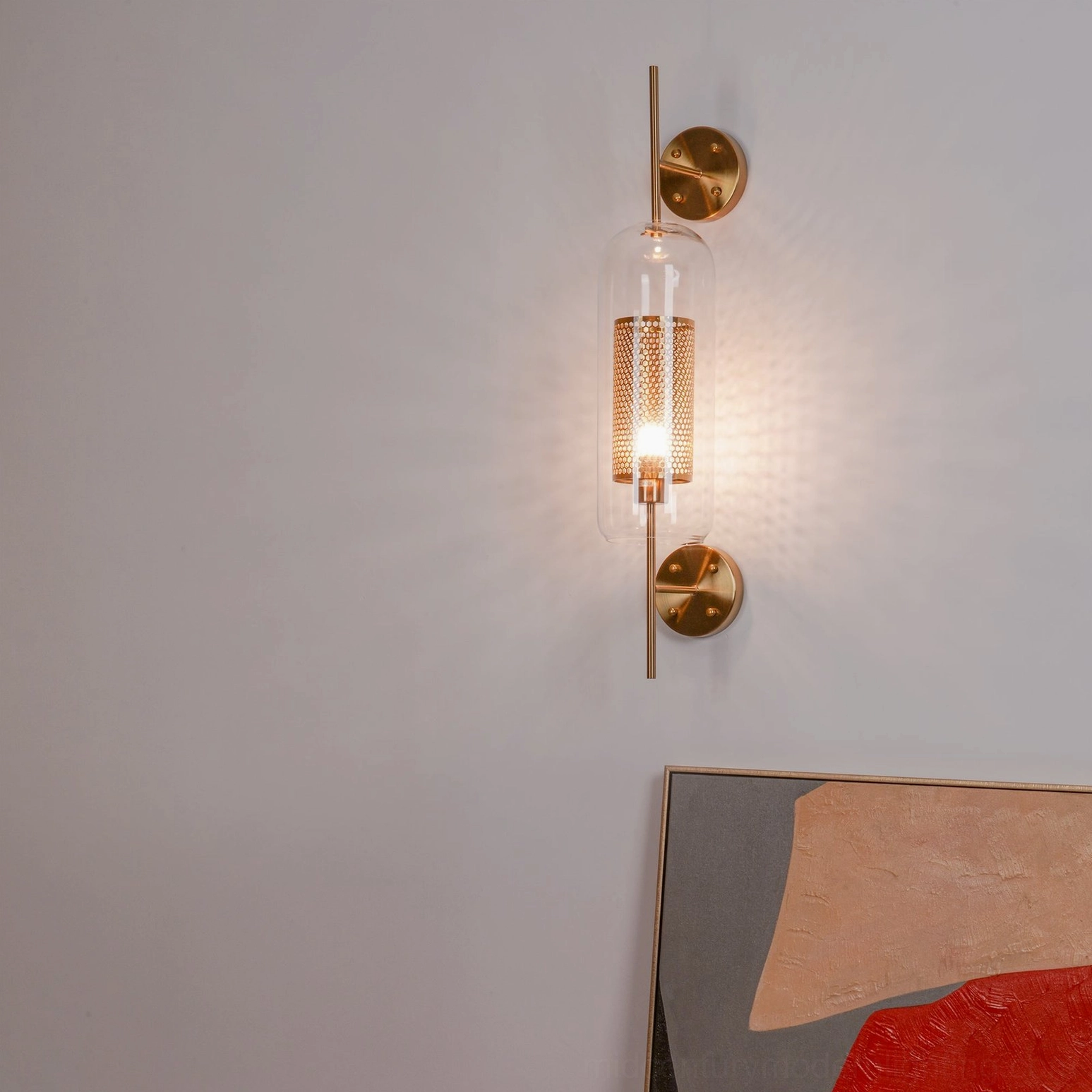 Contemporary glass sconce with clear glass and polished metal hardware finish