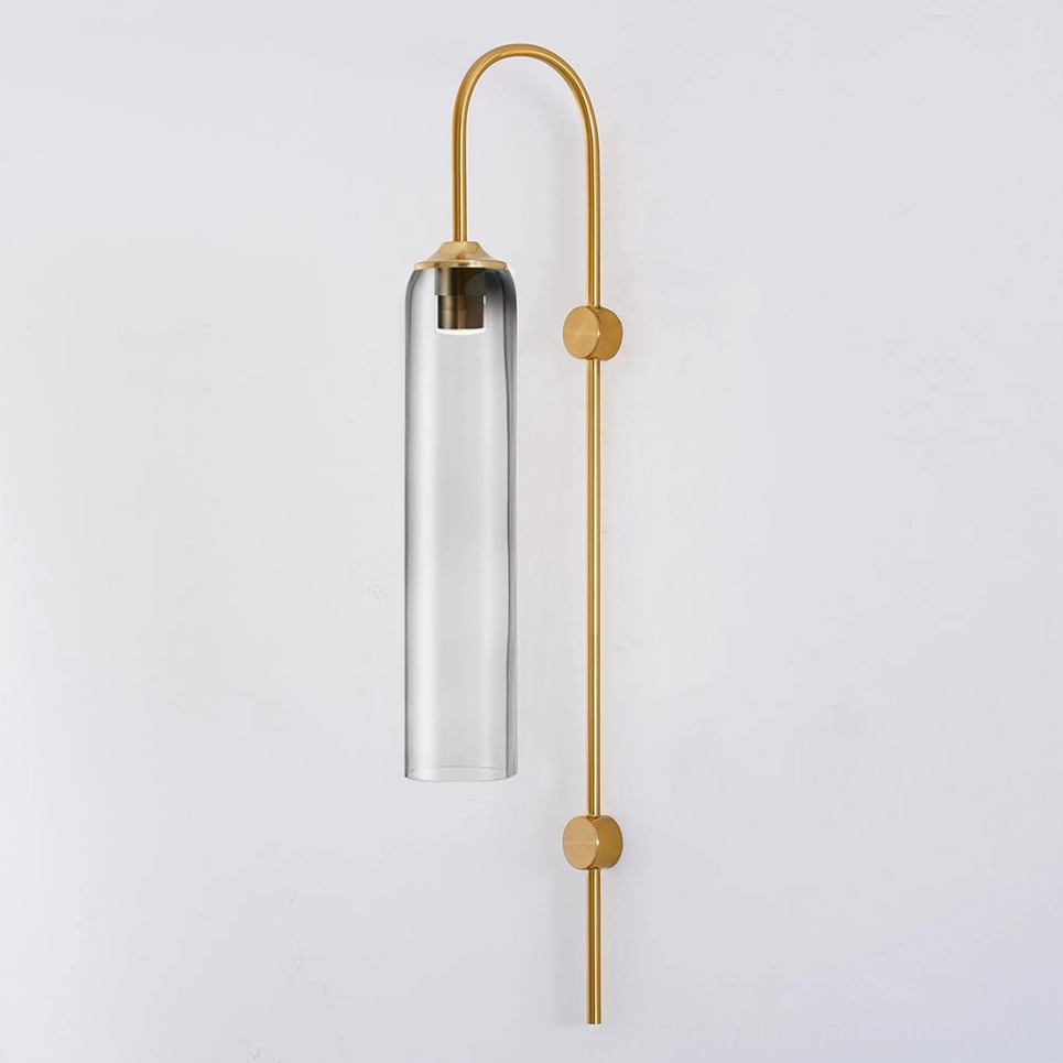 Crystal clear glass cylindrical wall sconce demonstrating transparent glass clarity and light refraction