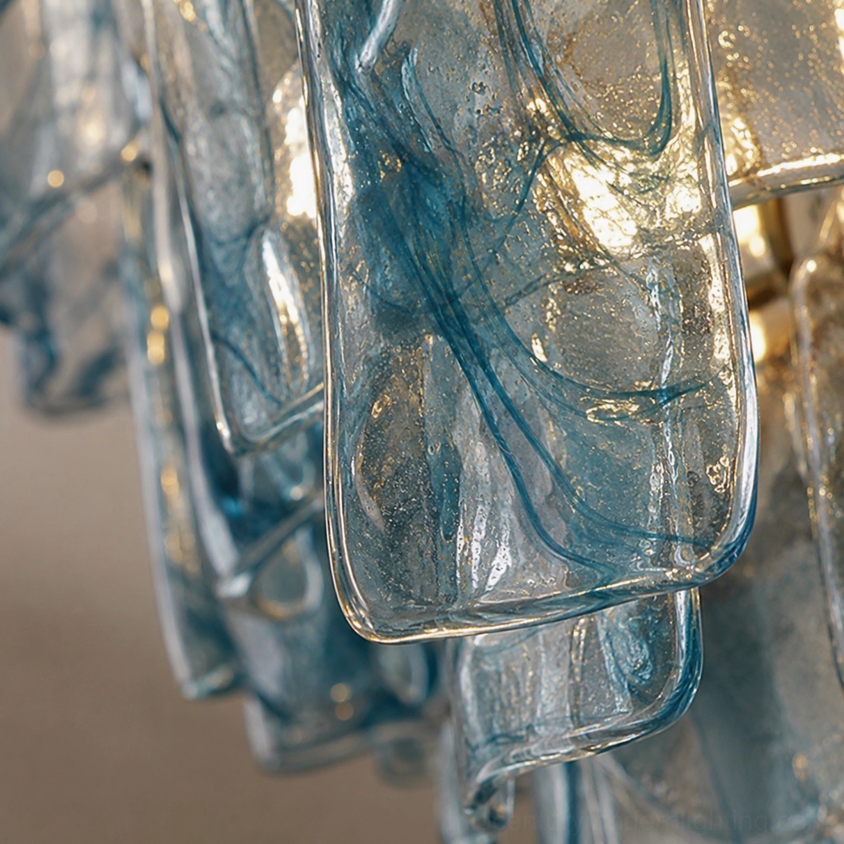 Close-up detail of blue marbled glass panels, tiered chandelier components showing textured surface and glossy finish, macro product photography