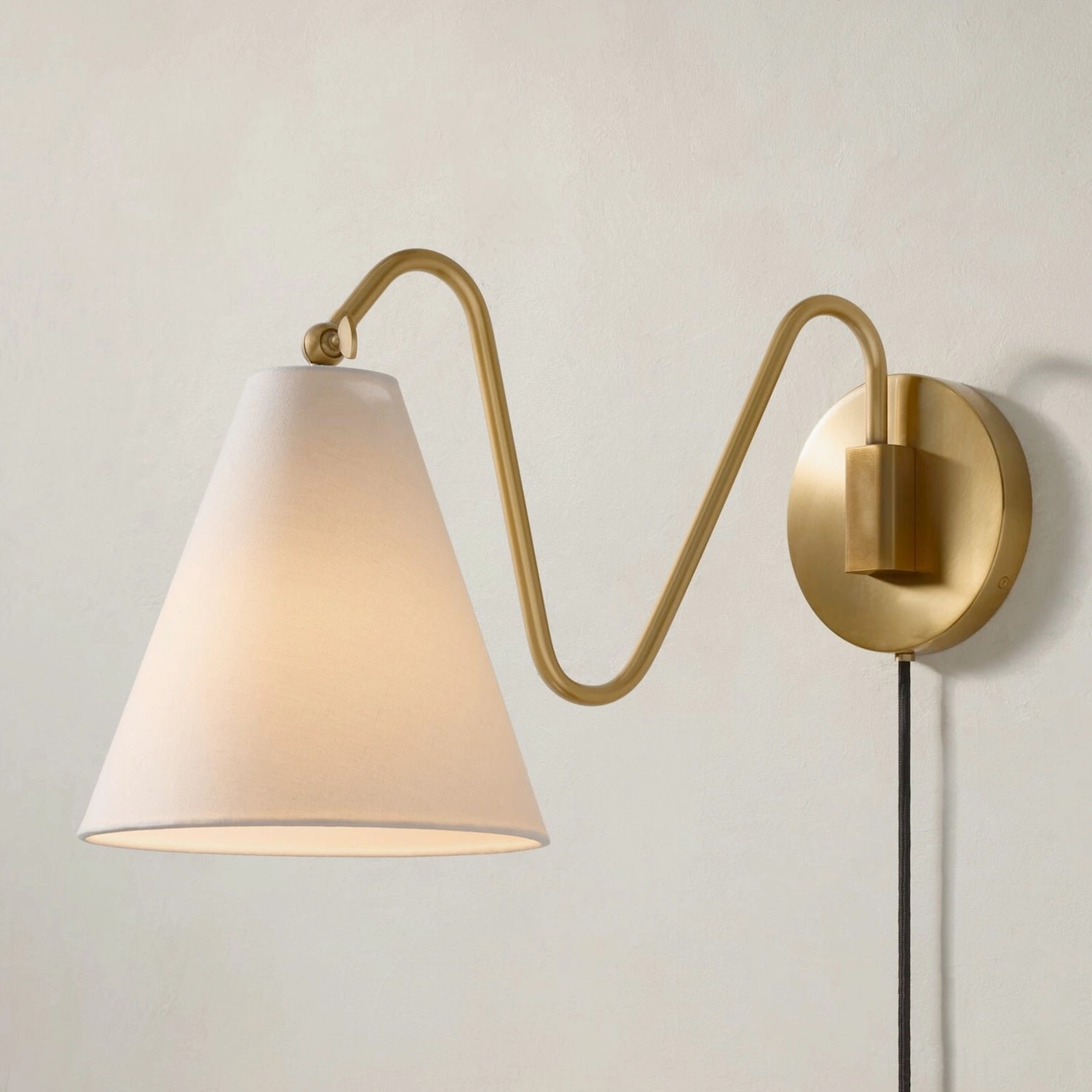 Cleome swing arm wall lamp architectural detail brass curved arm construction and finish