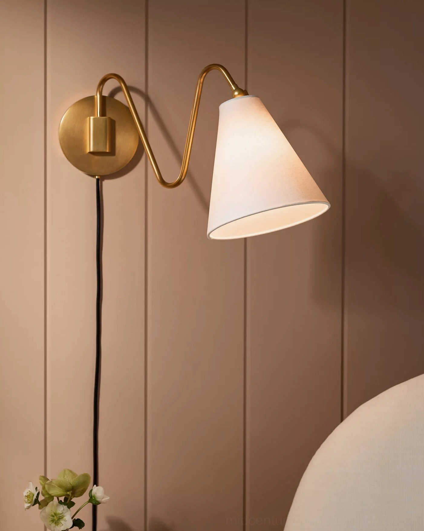 Close-up front view brass curved arm white fabric shade exposed cord plug-in installation