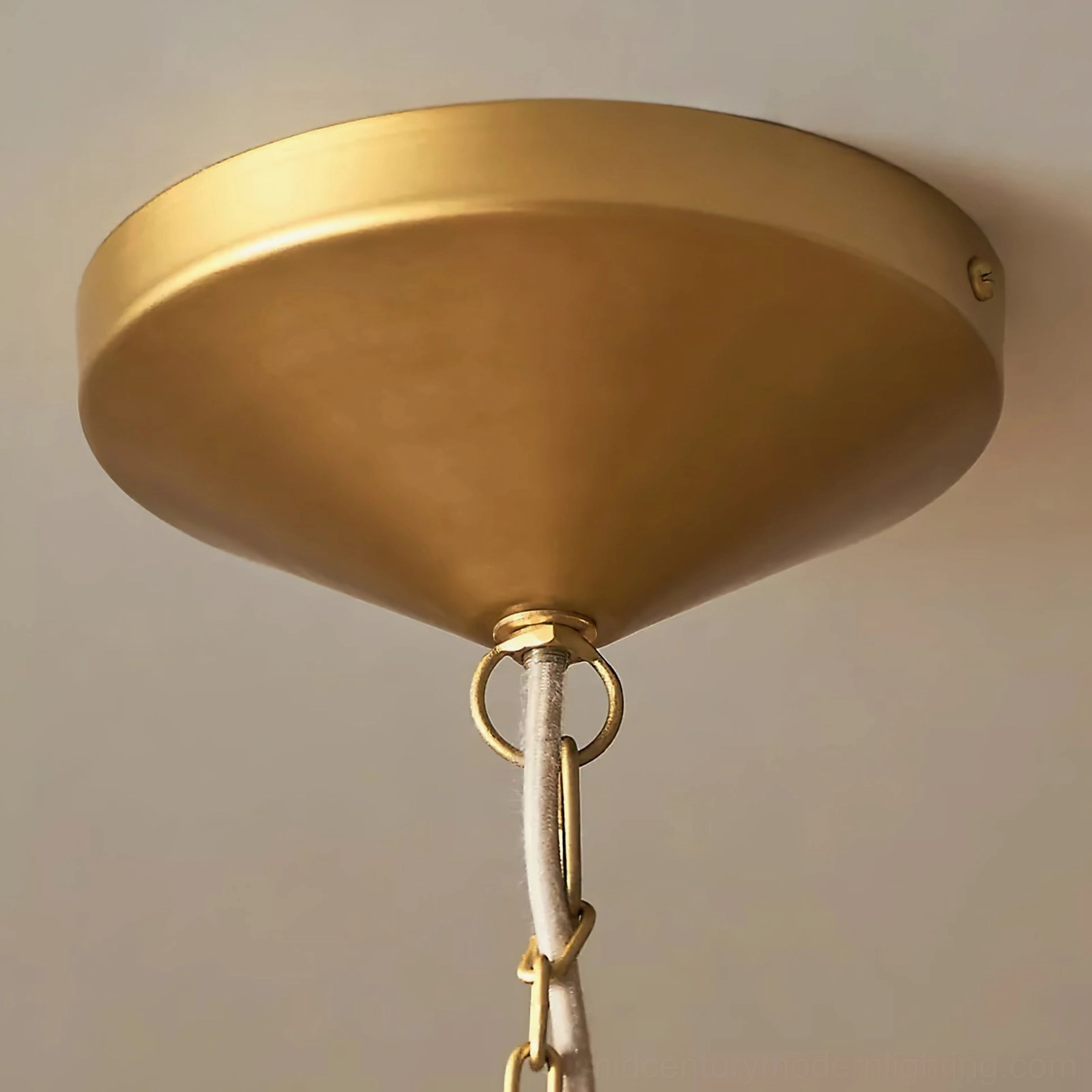 Close-up detail of Clivedon pendant frame, chain, and brushed brass hardware