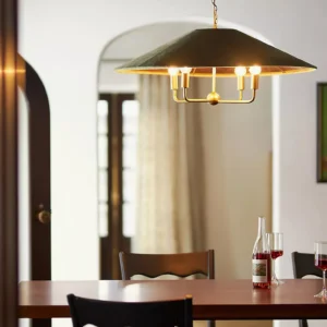 Clivedon pendant lamp illuminated over wooden dining table in modern interior setting